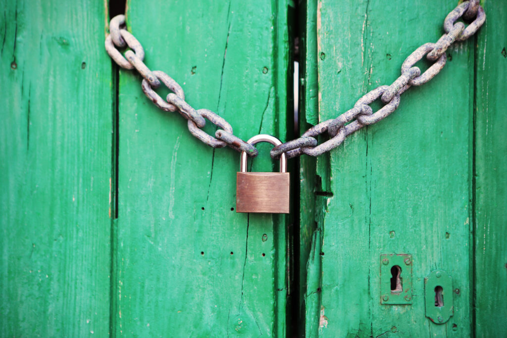 Green door with locked padlock